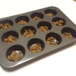 Use a cupcake tin to stop your dog inhaling food